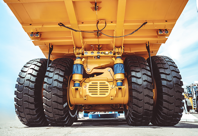 Underneath heavy construction dump truck